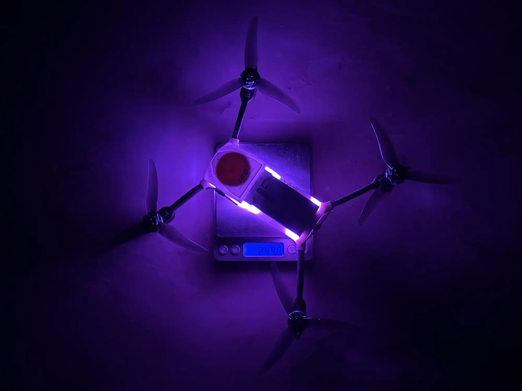 Aerolyt Nano drone placed on a weighing scale to demonstrate its lightweight design, ideal for the drone show business, with a weight exceeding 250 grams, highlighting cutting-edge drone technology